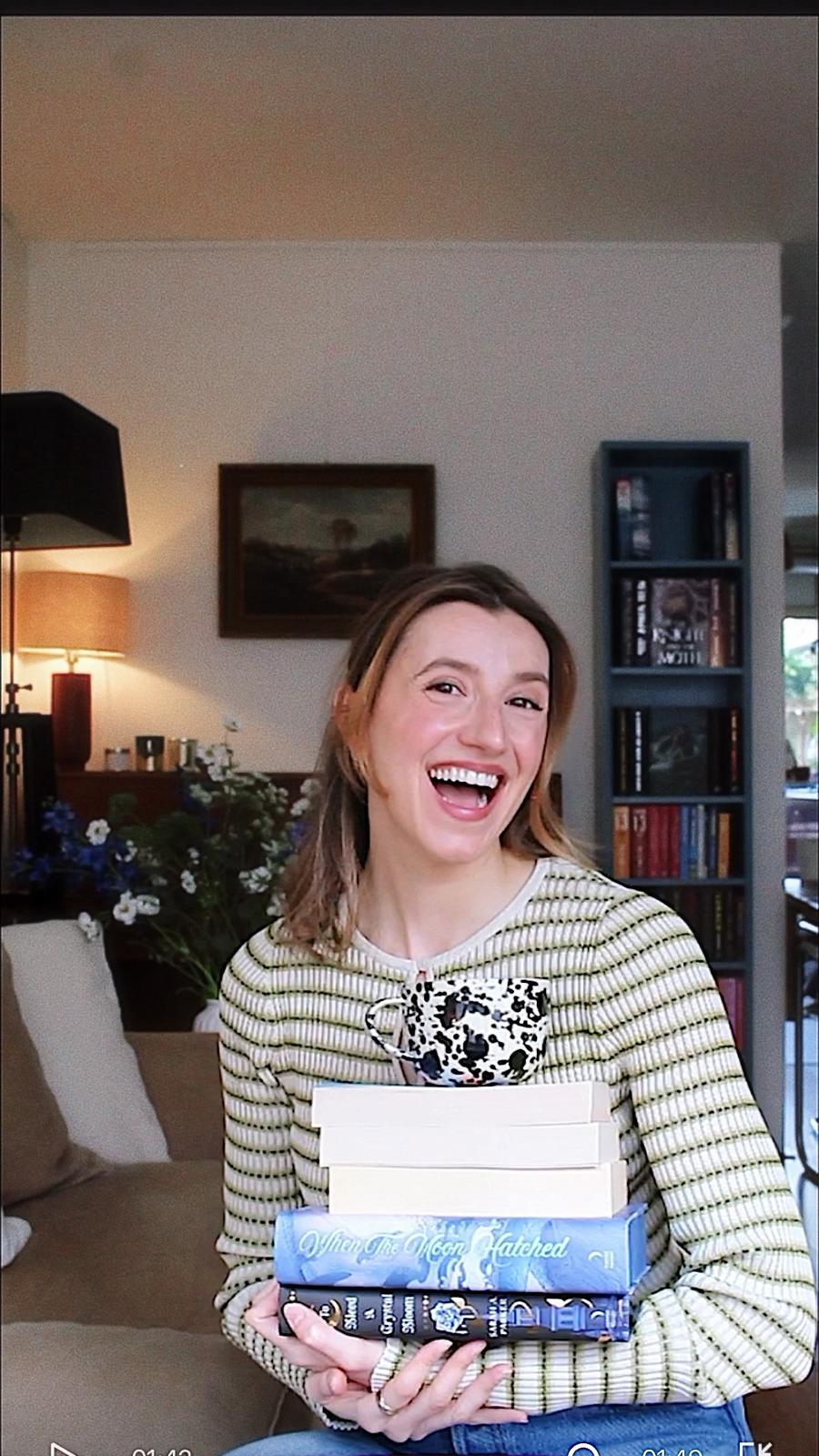 Emily holding a stack of books